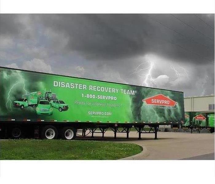 whirling storm cloud with SERVPRO truck